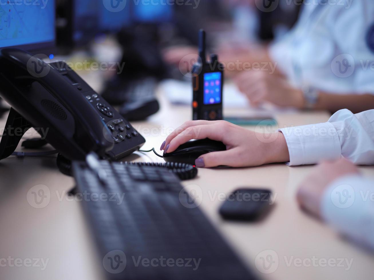 Female operator working in a security data system control room photo