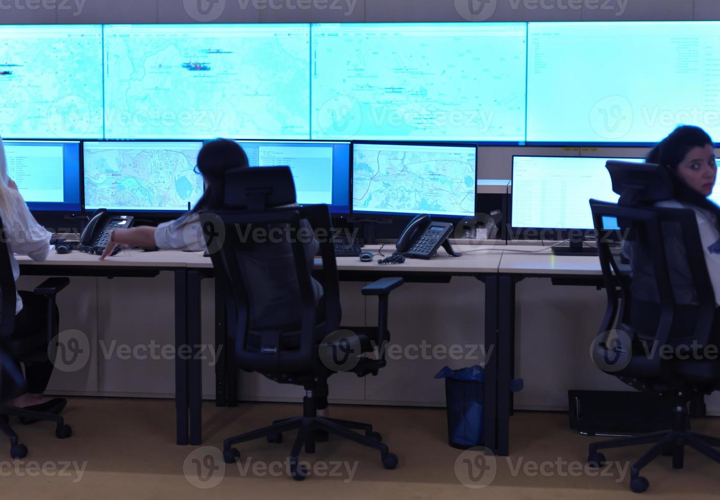 Female security guards working in a security data system control room photo