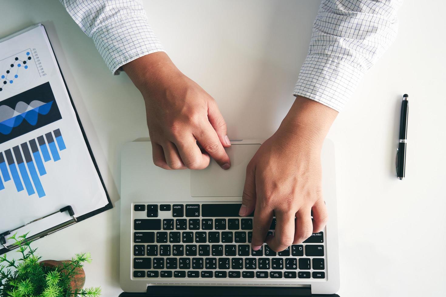 Man's hands using laptop photo