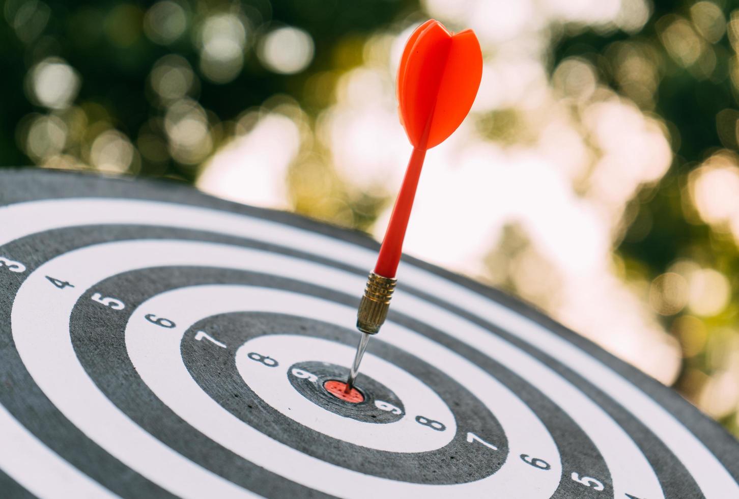 Target dart and arrow with abstract nature bokeh blur background photo