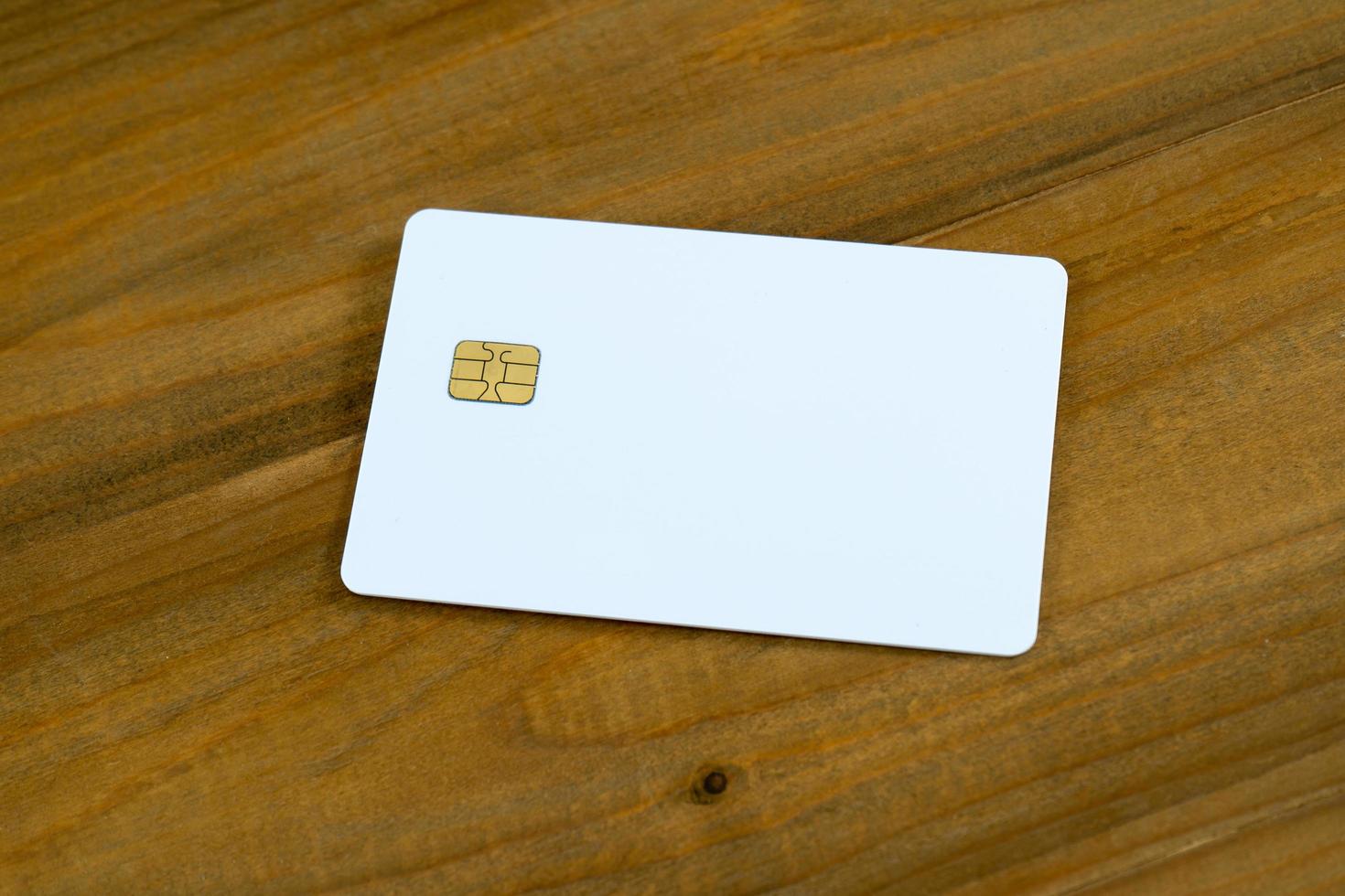 Blank credit card on wood background. photo