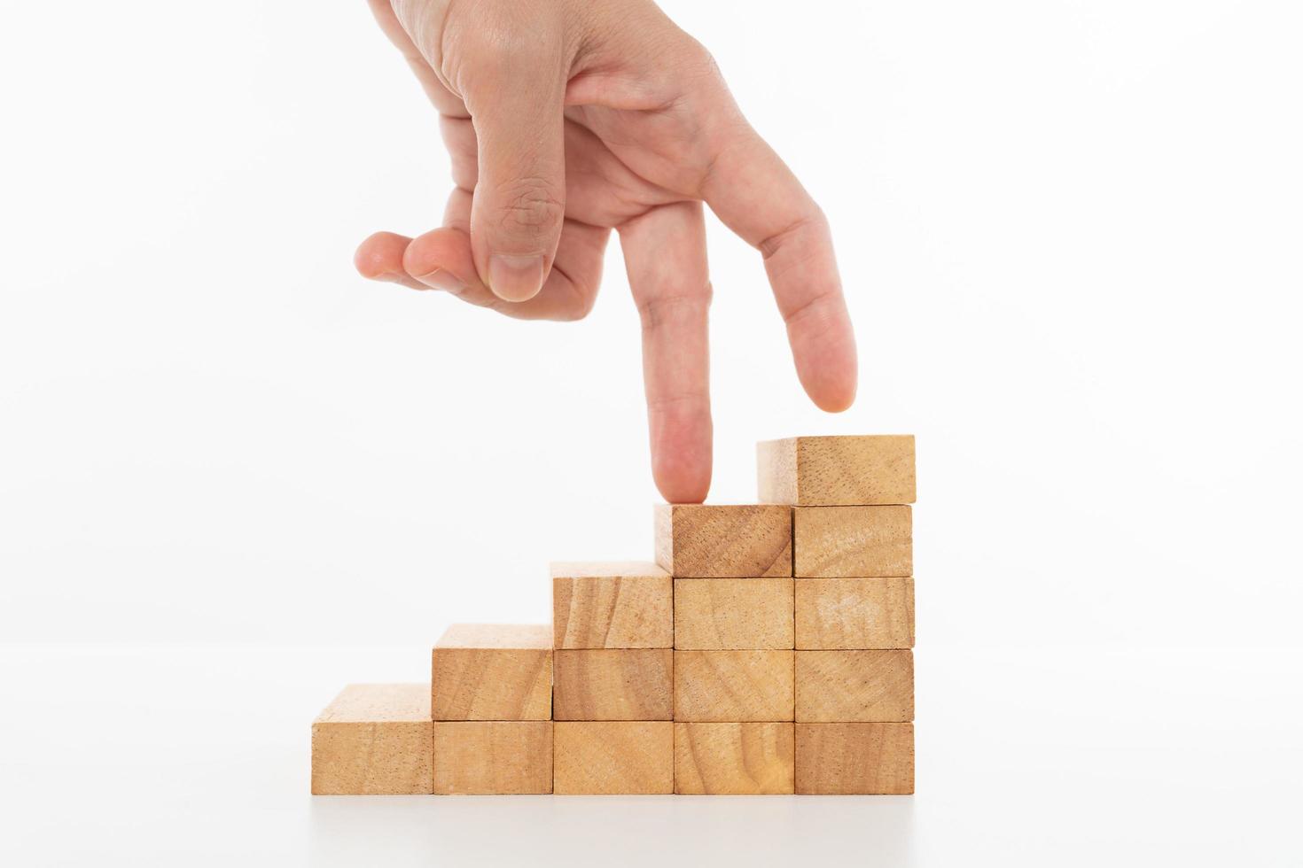 Women hand finger walk on stacked wooden block.Business concept growth success process photo