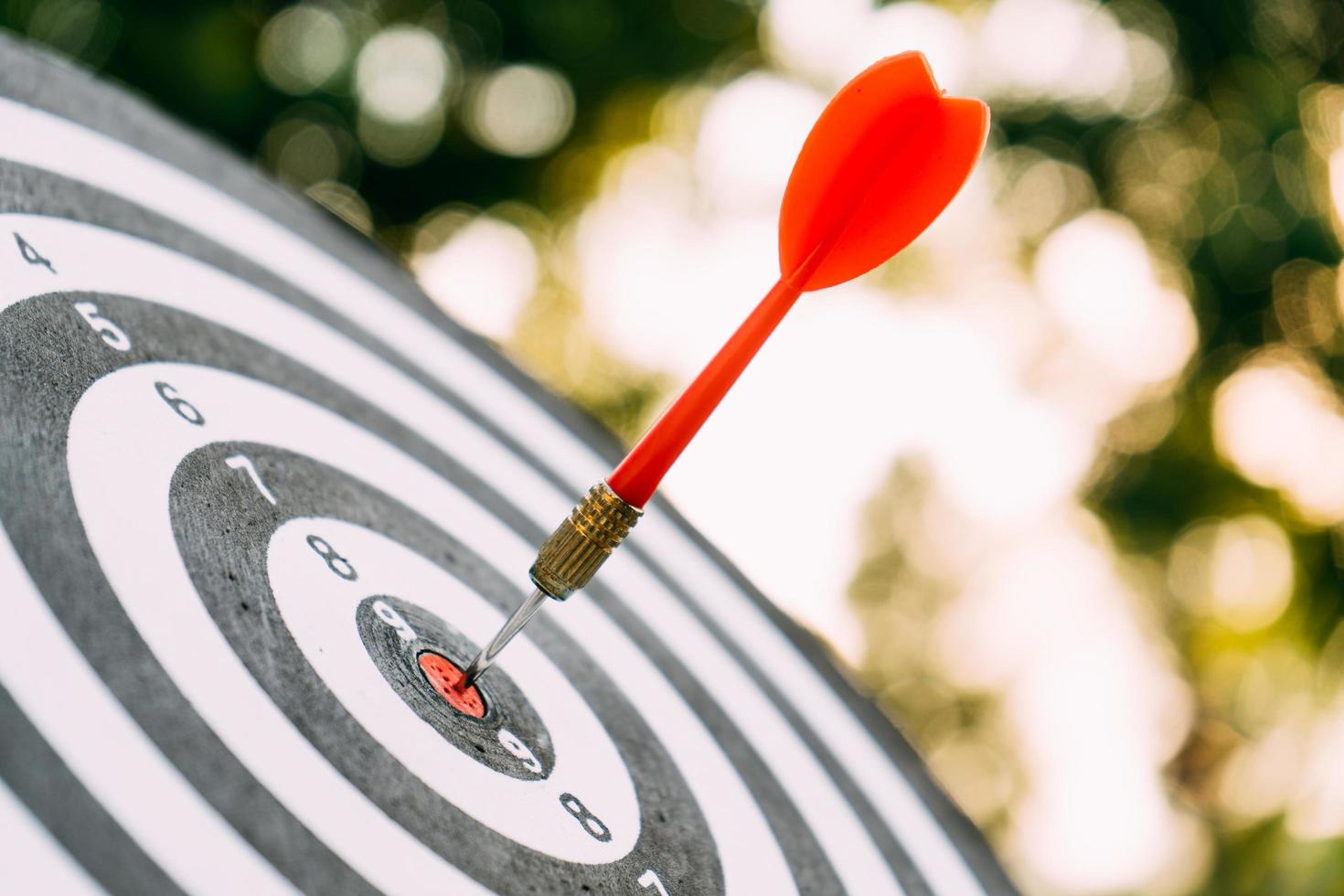 Target dart and arrow with abstract nature bokeh blur background photo