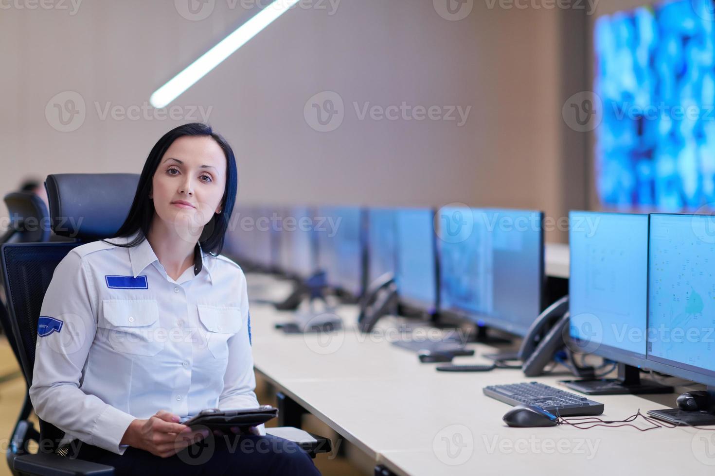 portrait of Female operator in a security data system control room photo
