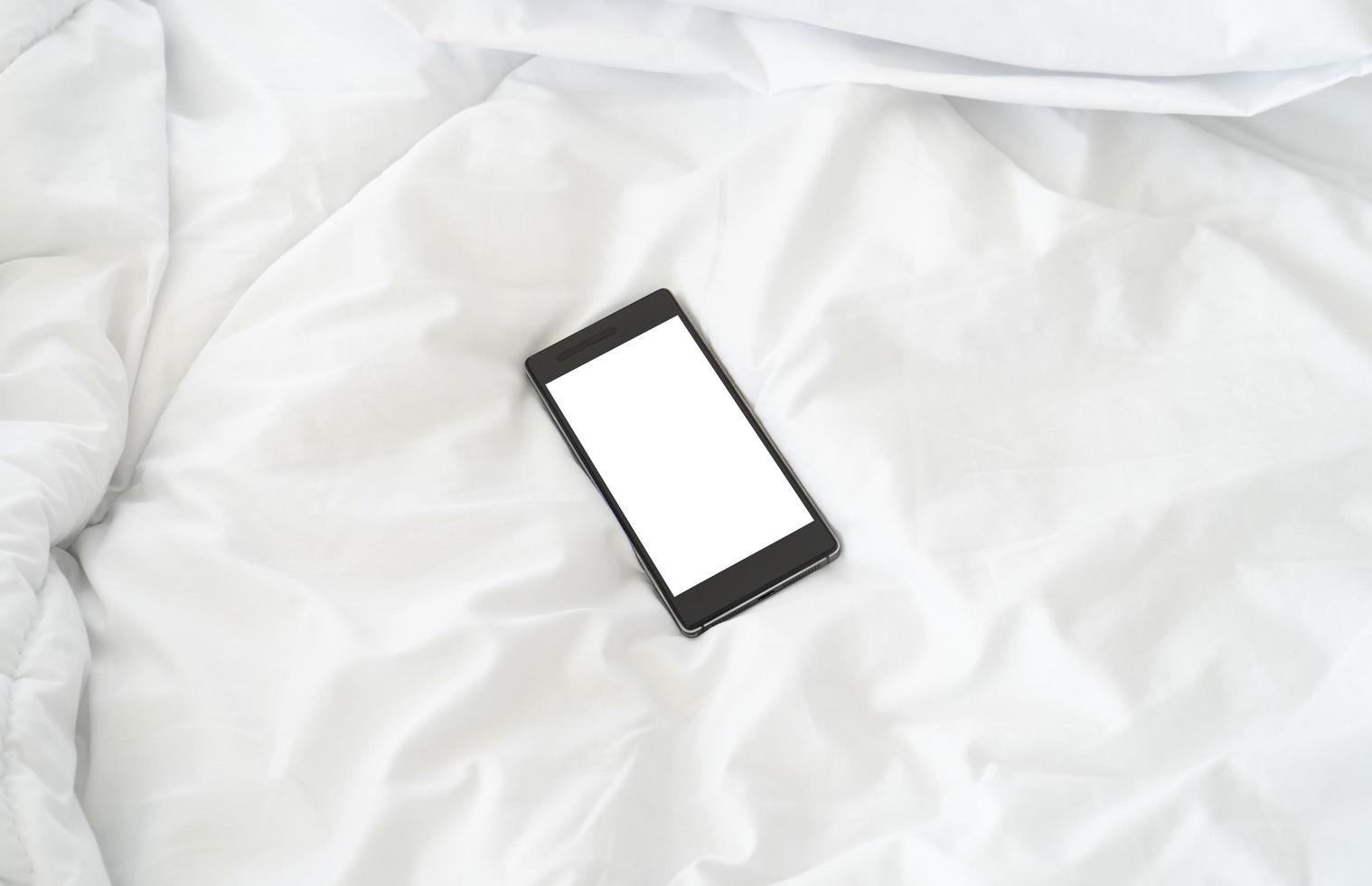 Smartphone on the bed photo