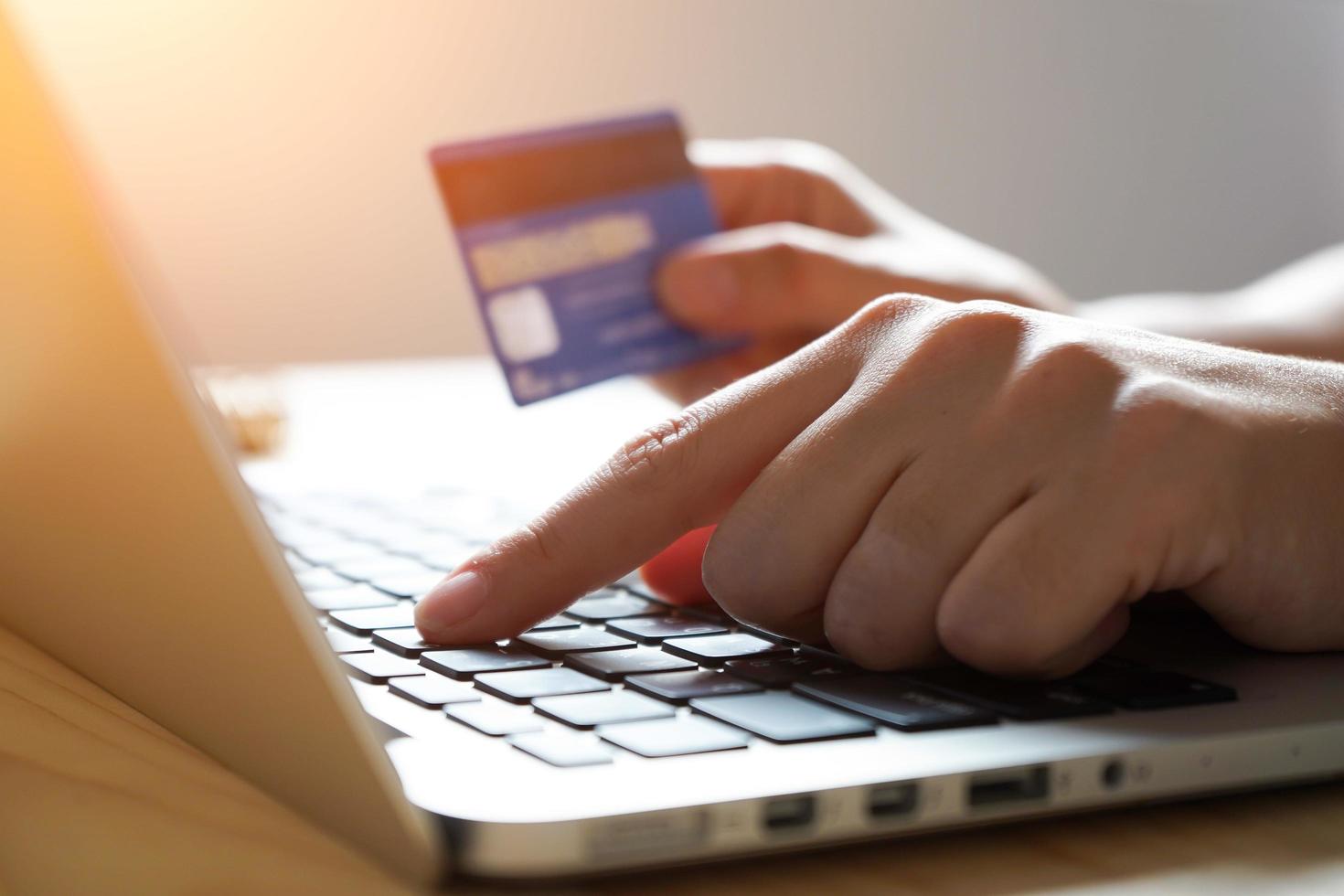 Hands using laptop computer for online shopping at home photo