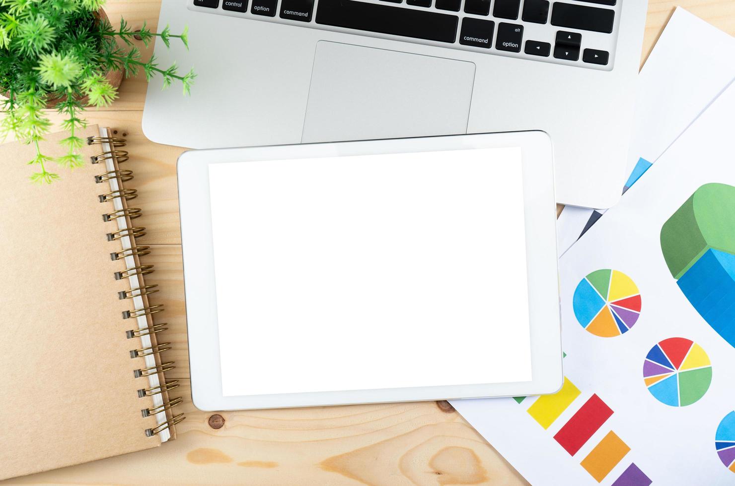 Office table top view and tablet with blank white screen photo