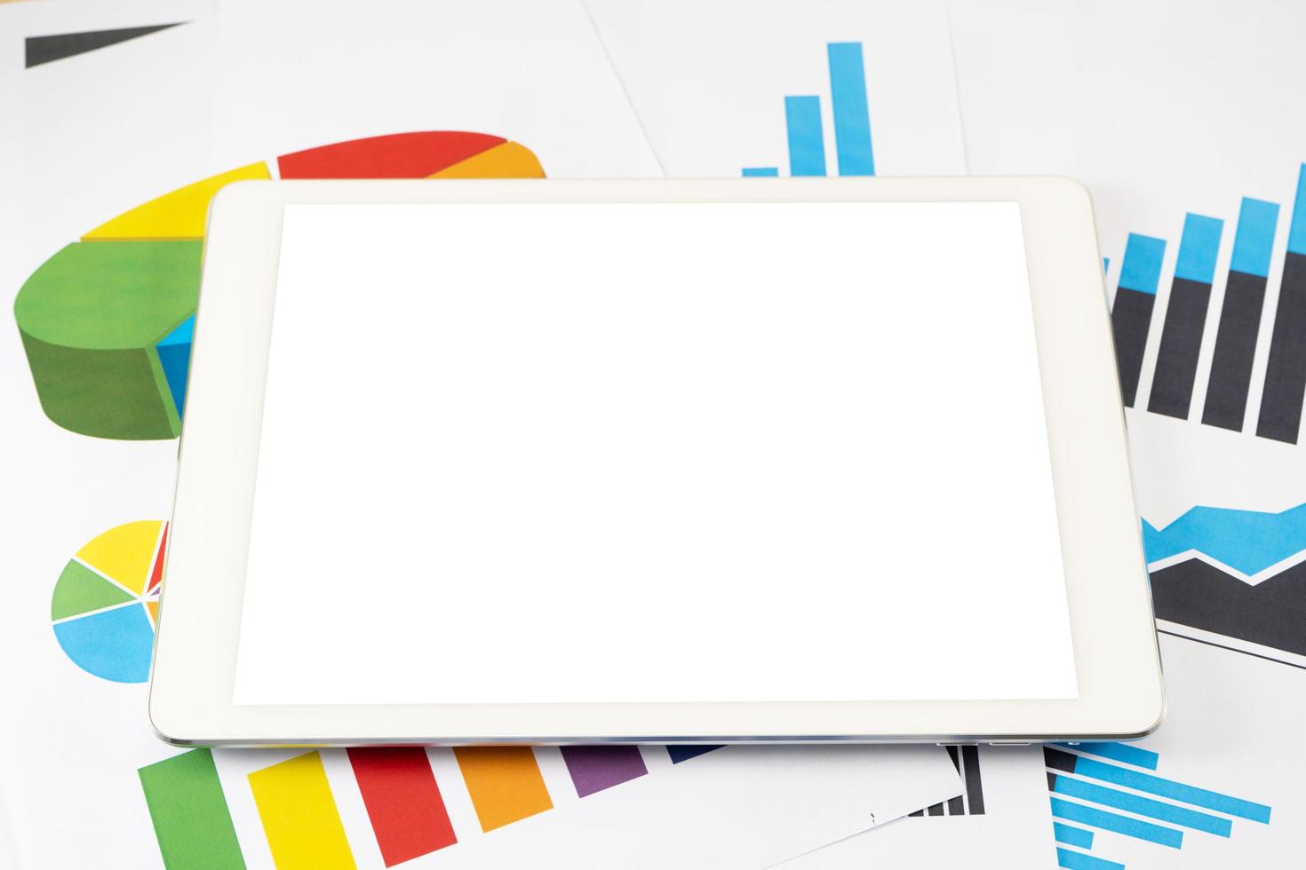 Blank white screen tablet on business graph photo
