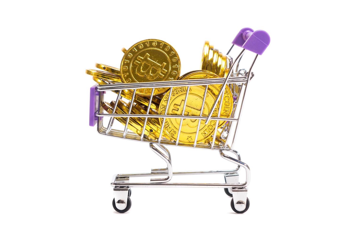 Golden Bitcoin on cart on white background photo