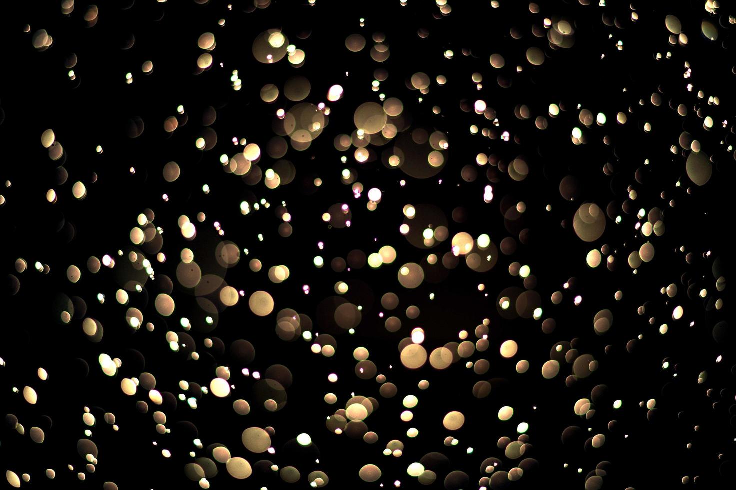 Bokeh de oro abstracto con fondo negro foto