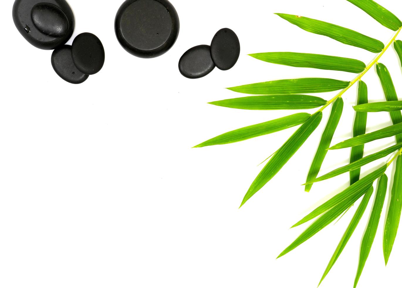 zen basalt stones and bamboo on white photo