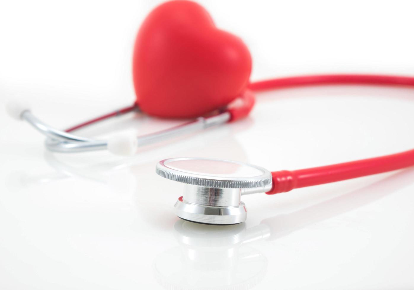 Stethoscope and red heart on white background photo