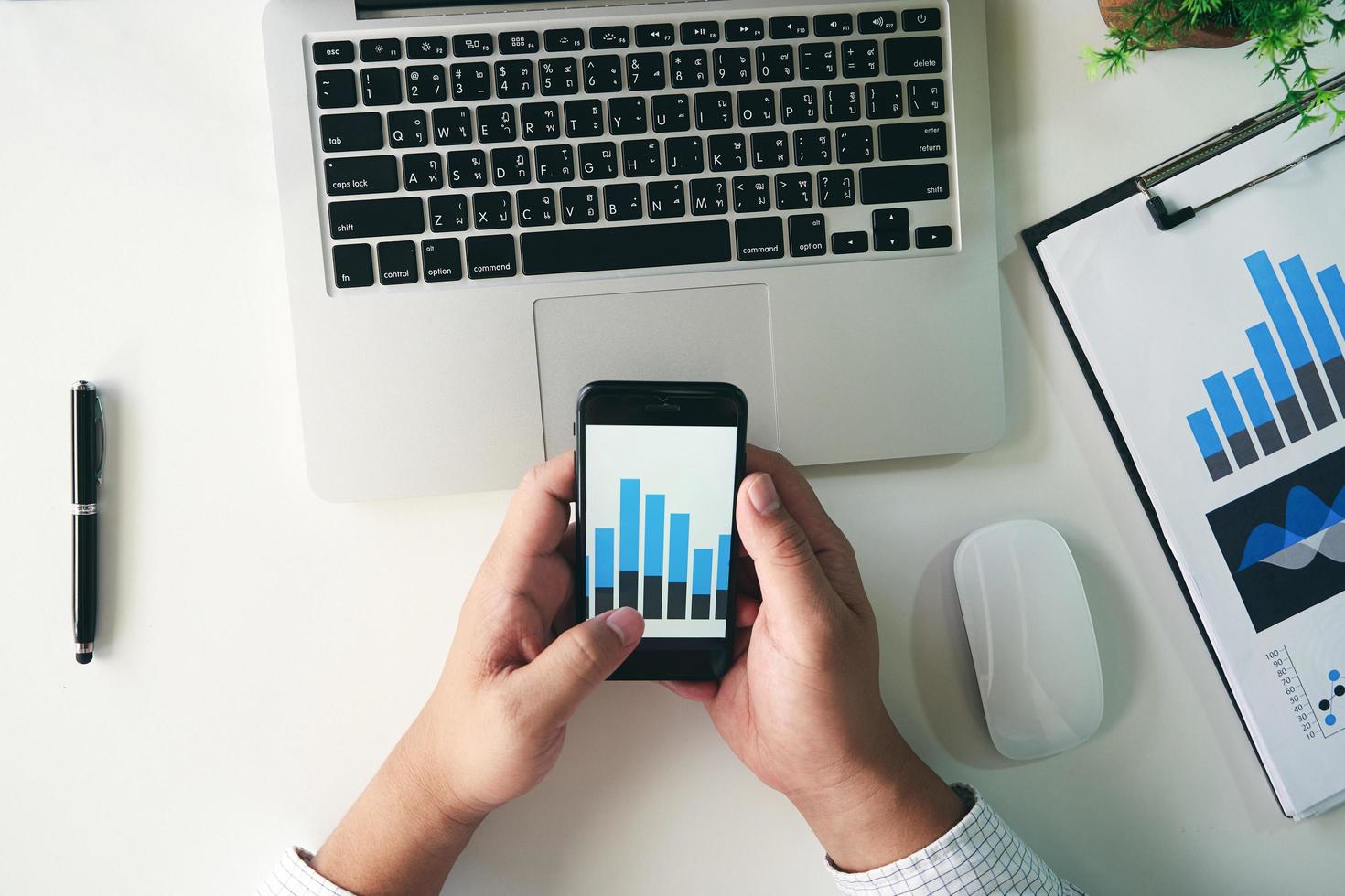 Businessman analyzing financial data on smartphone photo