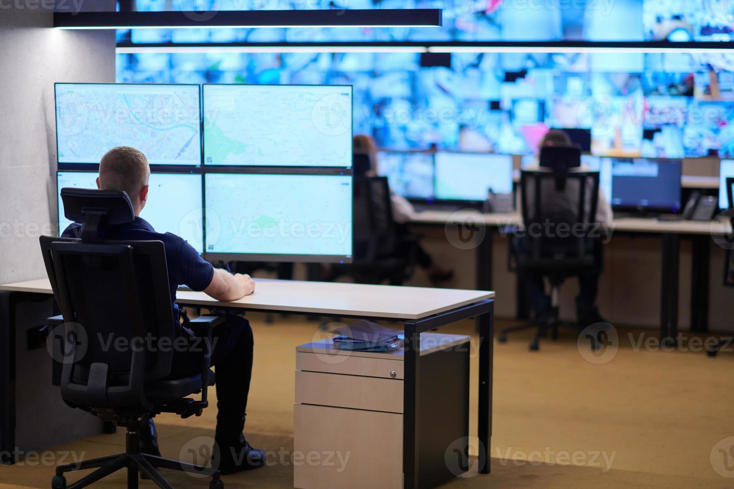 male operator working in a security data system control room photo