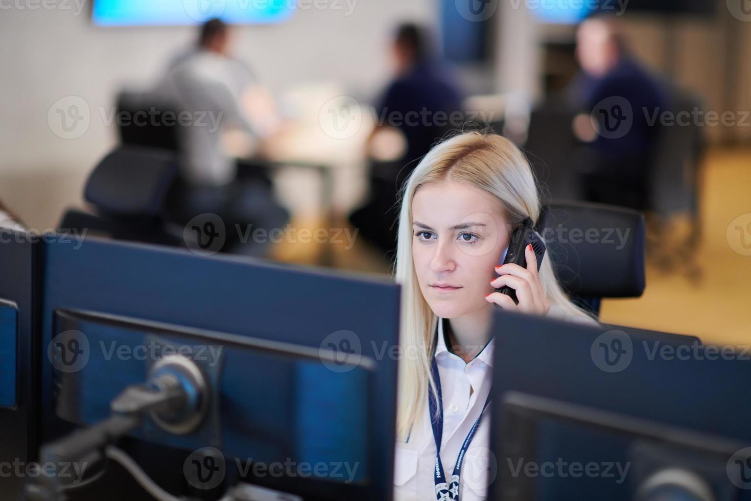 Female security guard operator talking on the phone photo