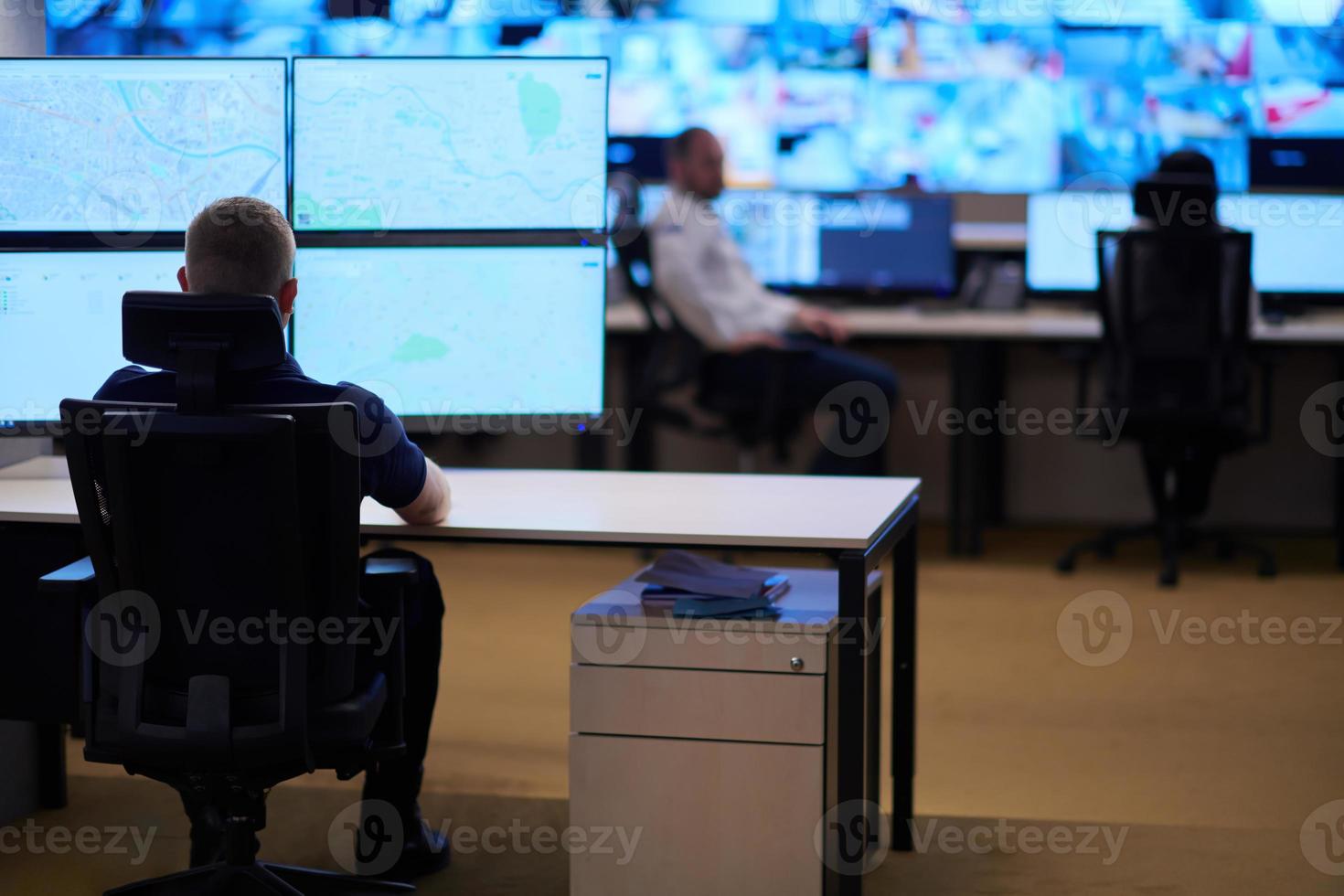 male operator working in a security data system control room photo