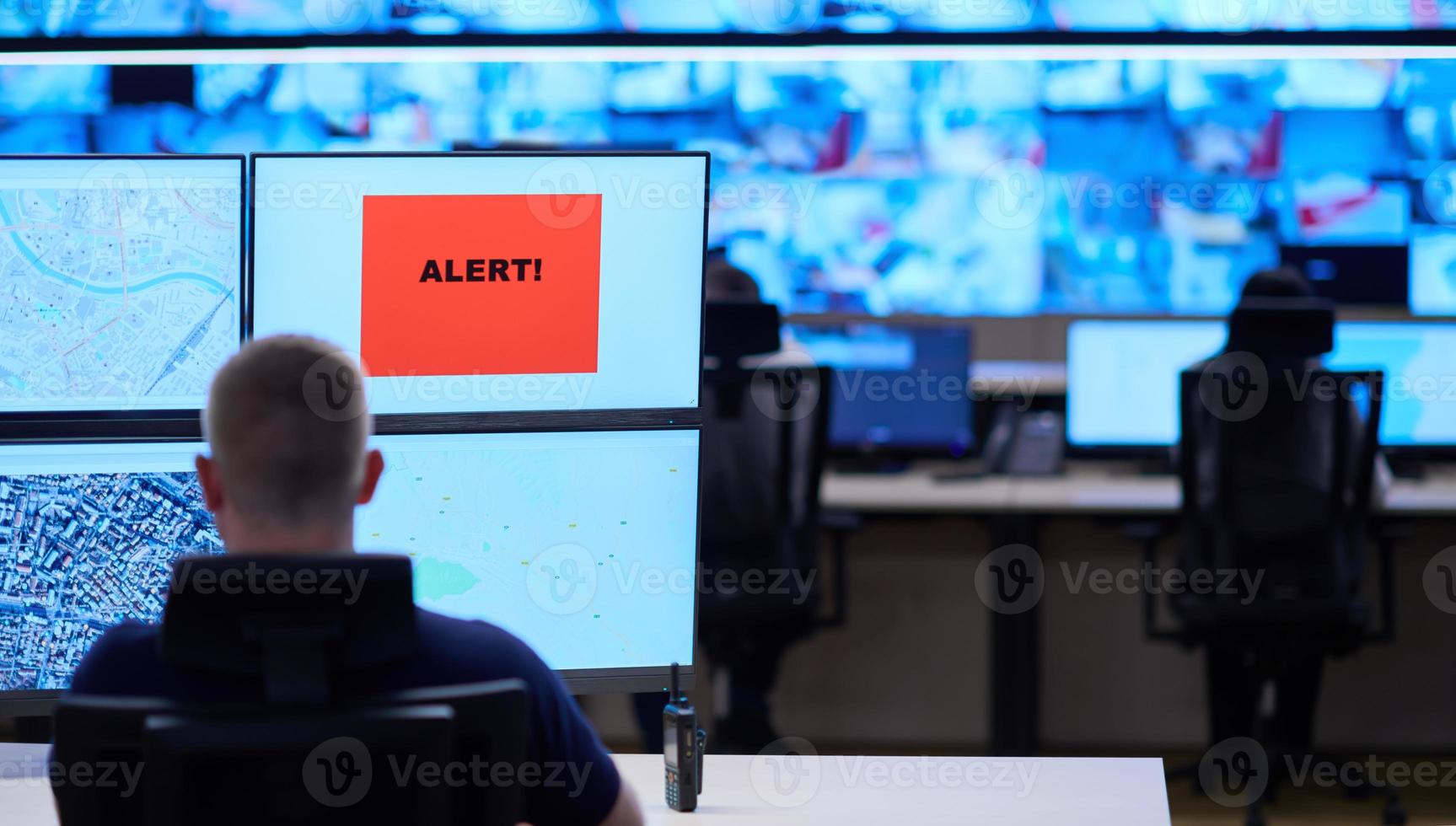 young male operator working in a security data system control room photo