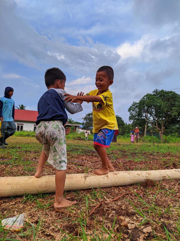 children playing together, east kalimantan, indonesia, august, 13,2022 photo