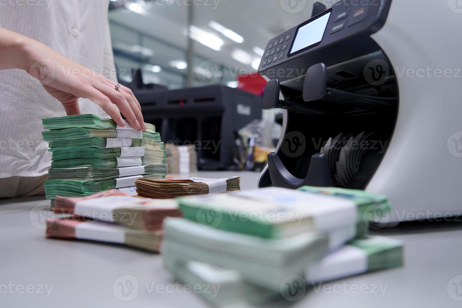 Bank employees sorting and counting paper banknotes photo