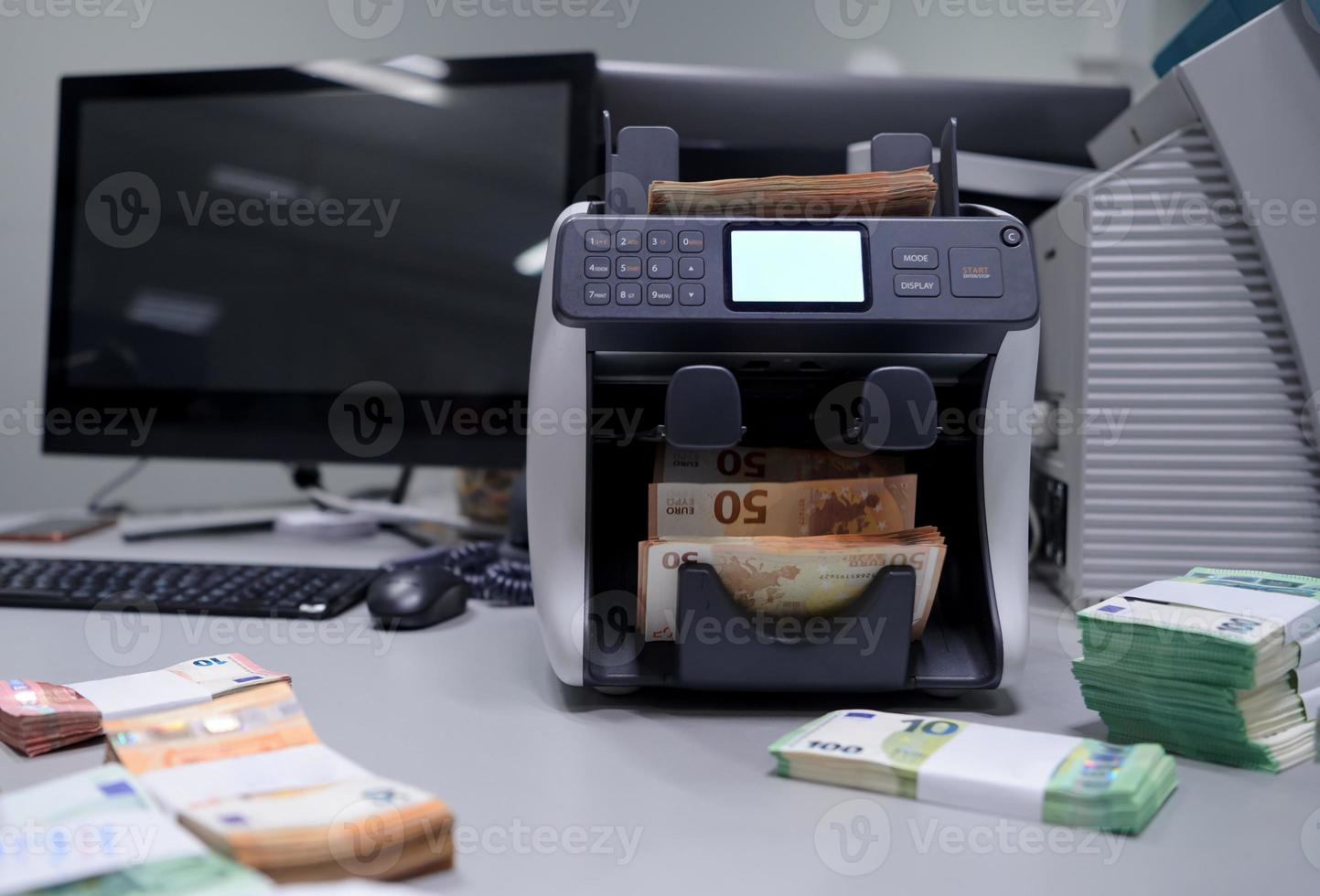 banknotes in front of electronic money counting machine photo