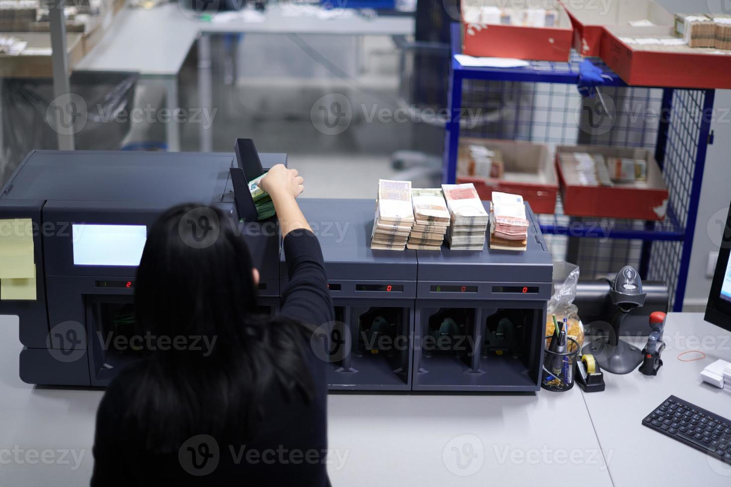 Bank employees sorting and counting paper banknotes photo