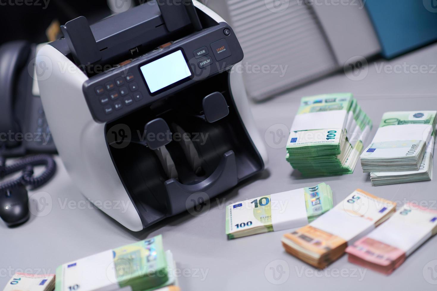 banknotes in front of electronic money counting machine photo