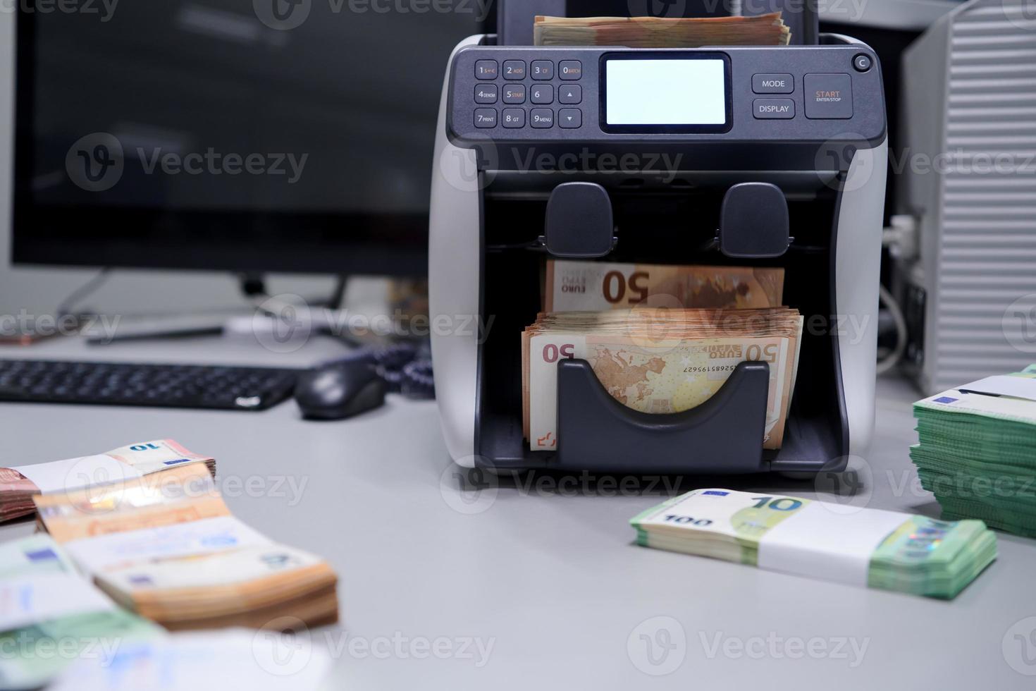banknotes in front of electronic money counting machine photo