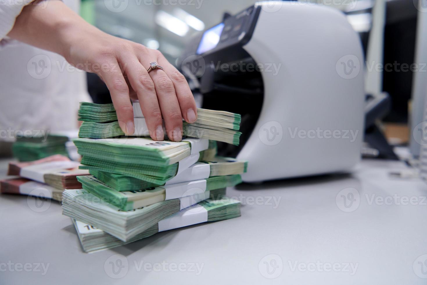 Bank employees sorting and counting paper banknotes photo