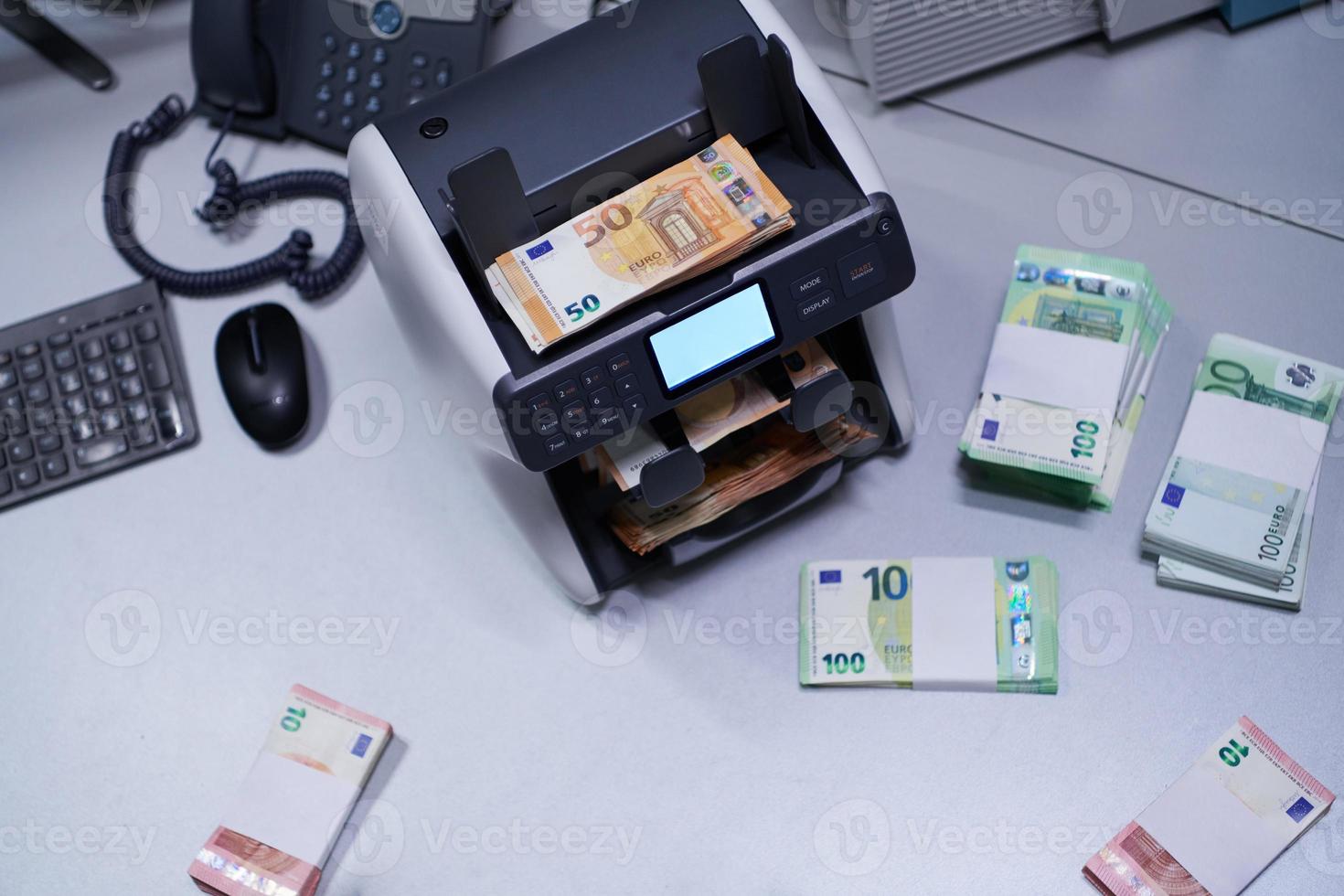 banknotes in front of electronic money counting machine photo