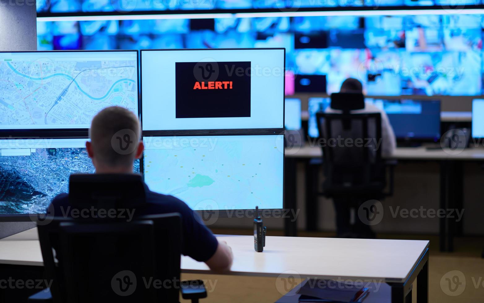 young male operator working in a security data system control room photo