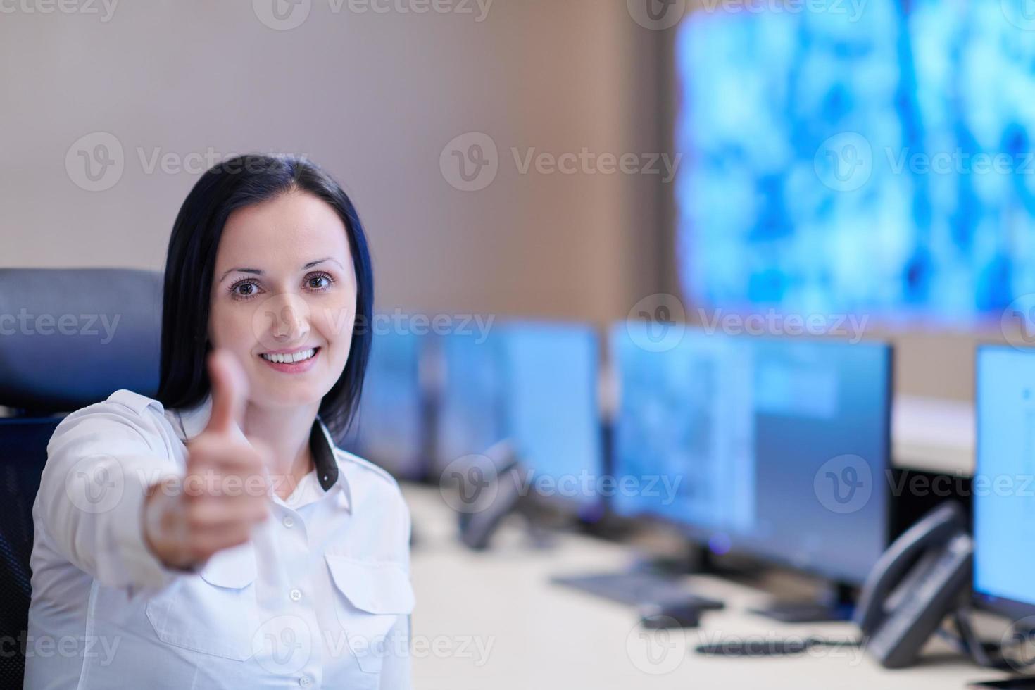portrait of Female operator in a security data system control room photo
