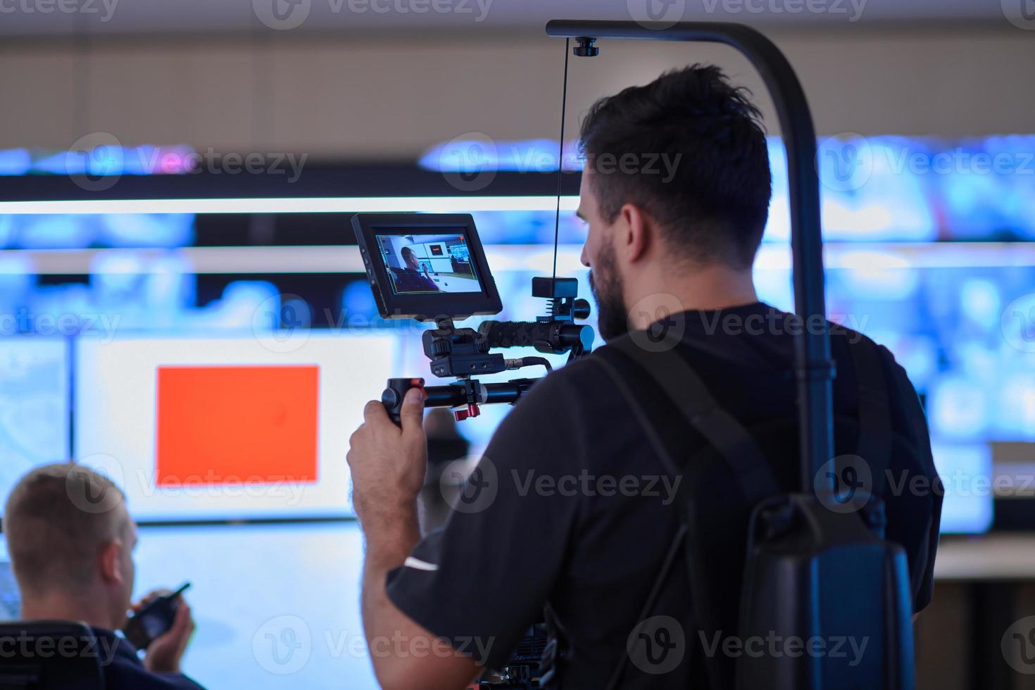 Professional videographer with gimball video slr recording video in Security data center photo