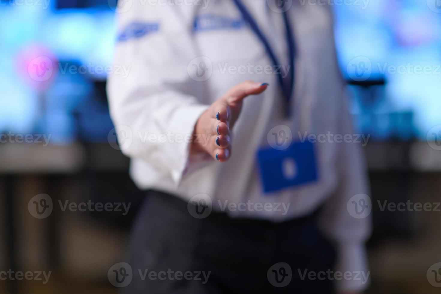 Female security operator extending a hand for a handshake photo