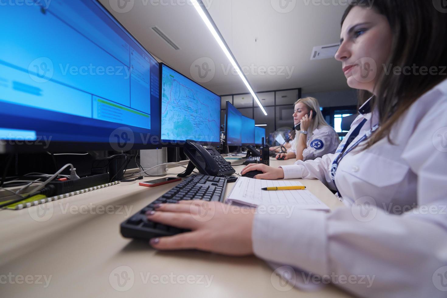 Female security guards working in a security data system control room photo