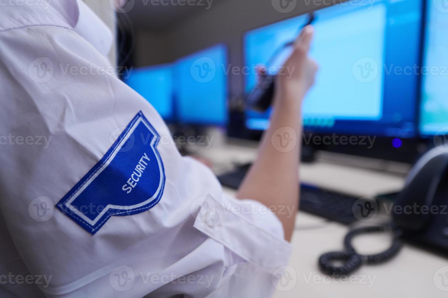 Female security operator holding portable radio in hand photo