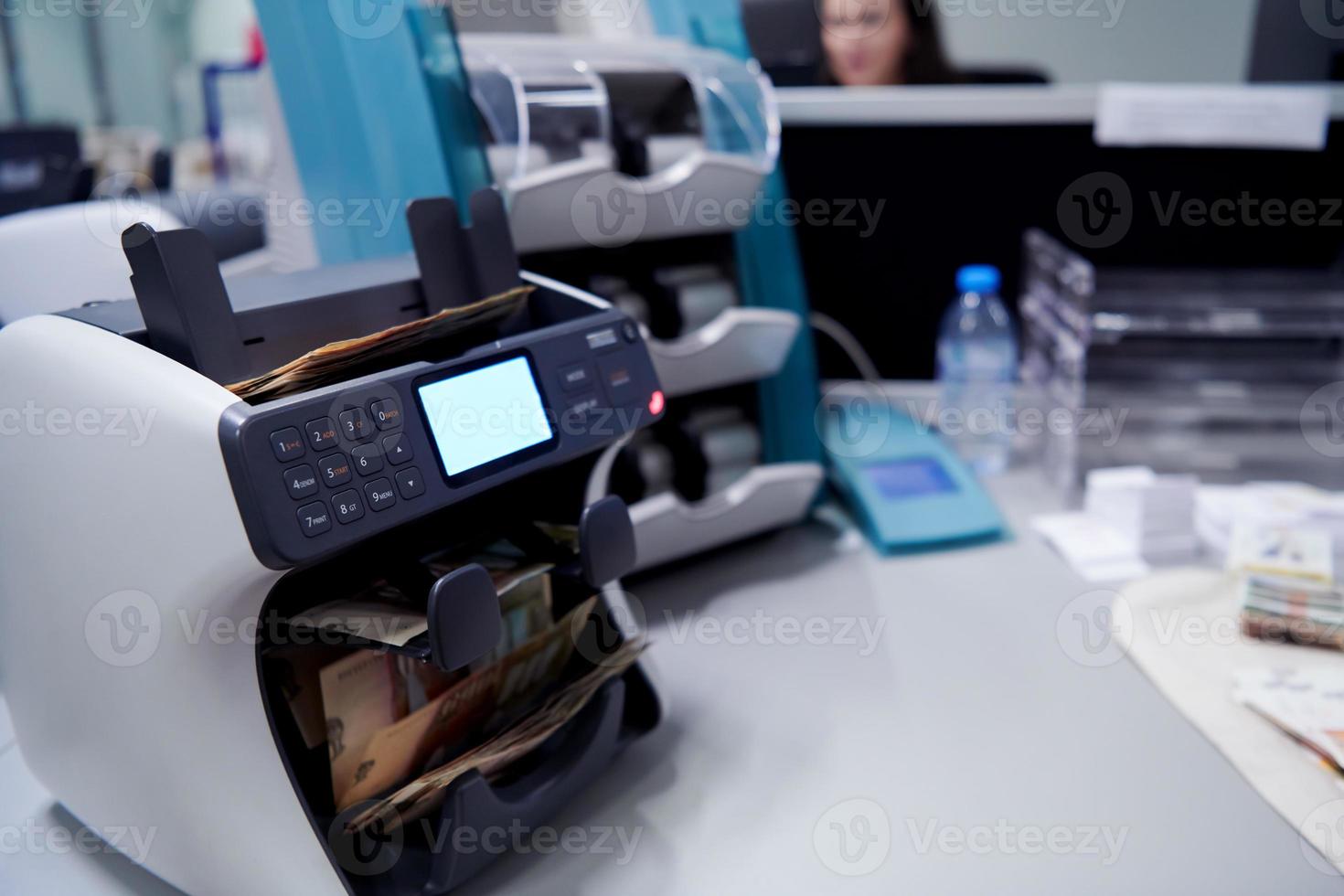 banknotes in front of electronic money counting machine photo