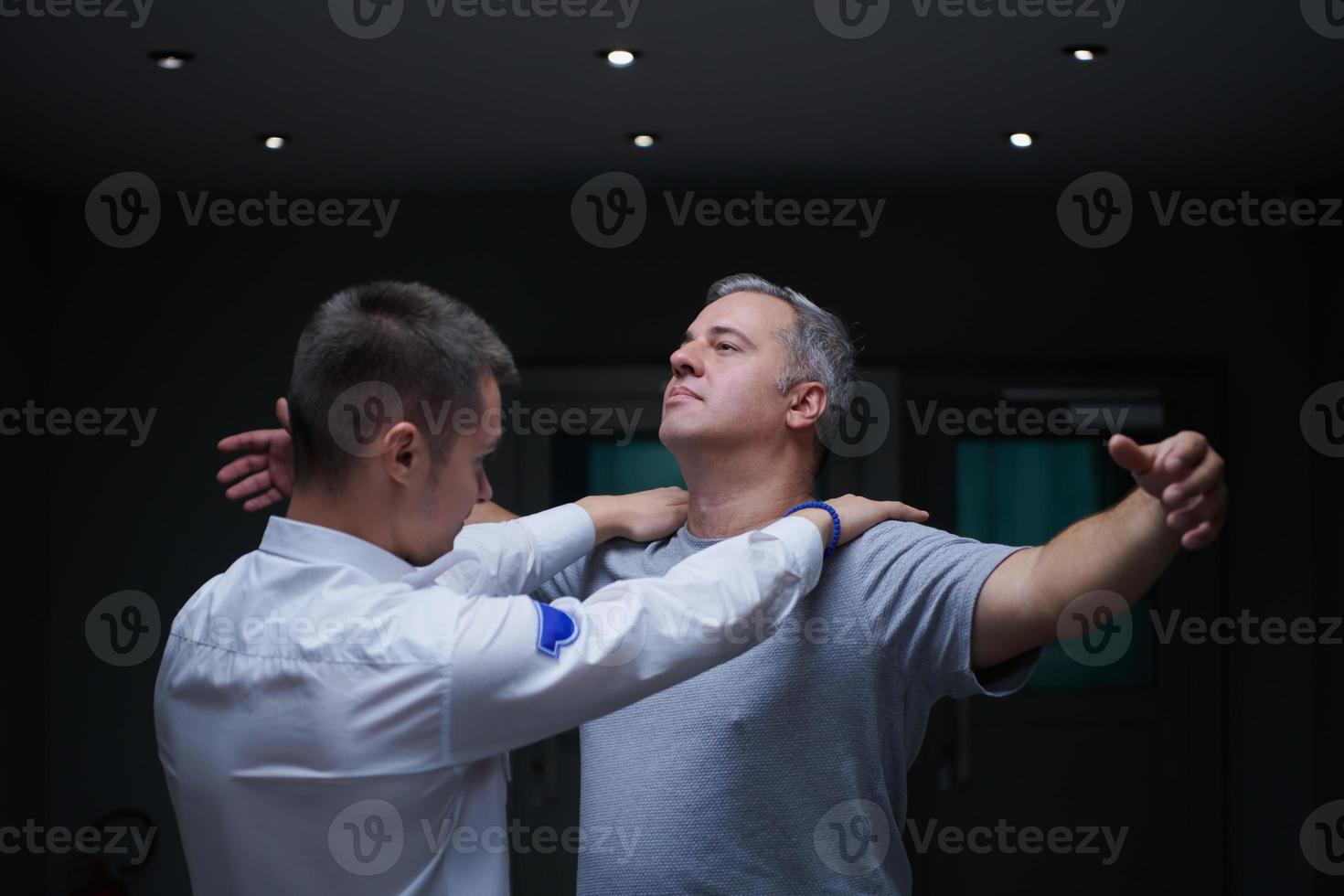 Security guard making body searching procedure on man photo