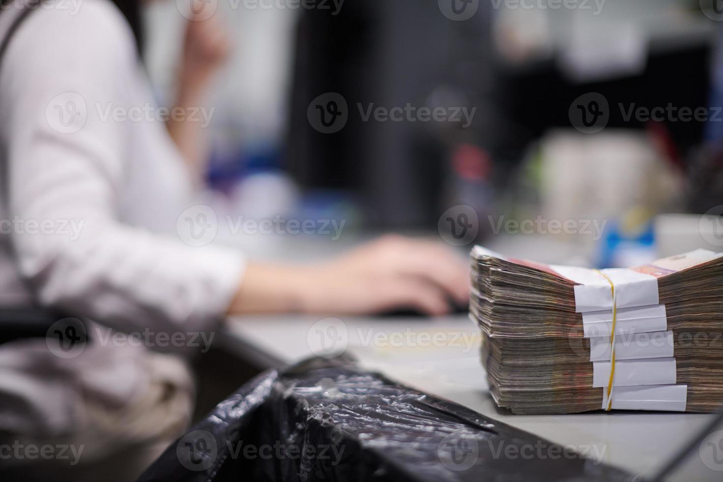 Bank employees sorting and counting paper banknotes photo