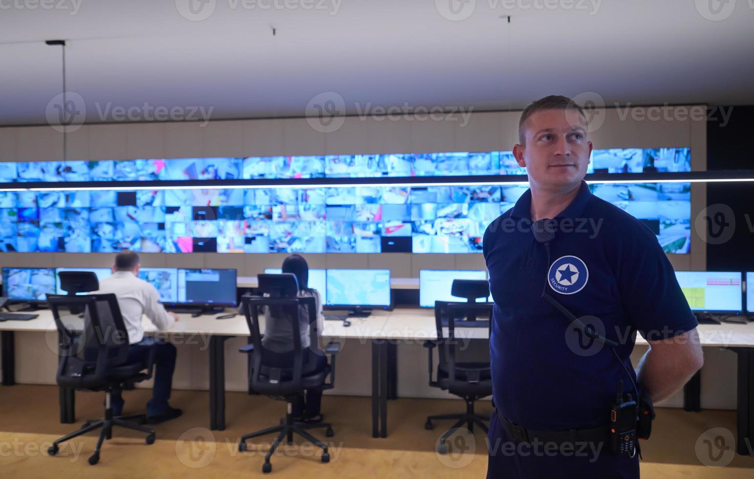 portrait of young male security operator in a data system control room photo