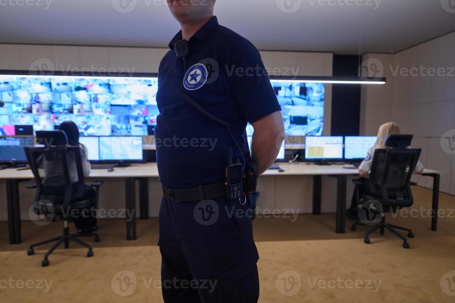 portrait of young male security operator in a data system control room photo