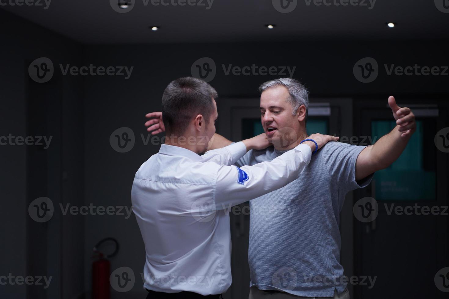 Security guard making body searching procedure on man photo