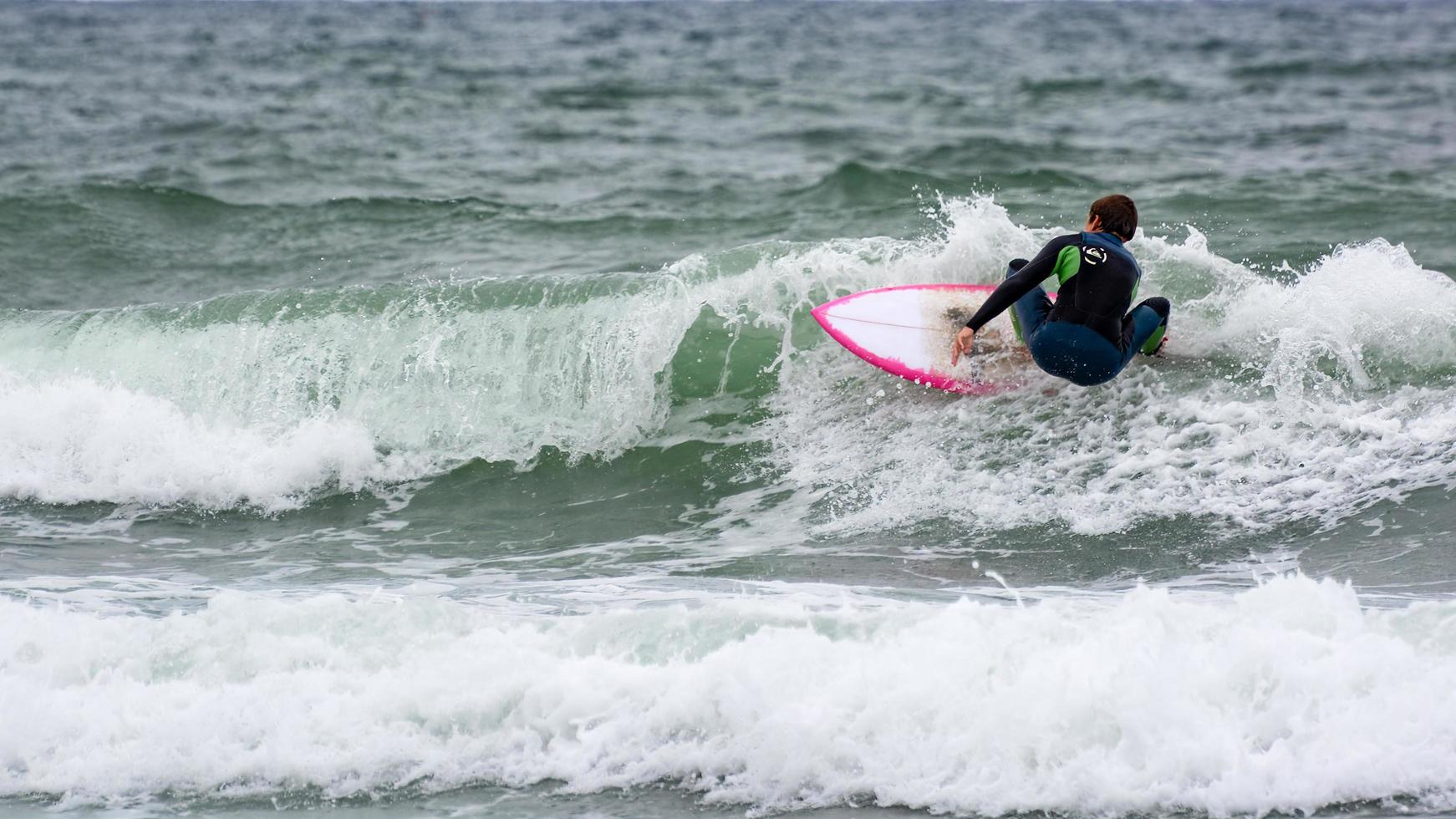 bude, cornwall, reino unido - 13 de agosto. surf en bude en cornwall el 13 de agosto de 2013. persona no identificada foto