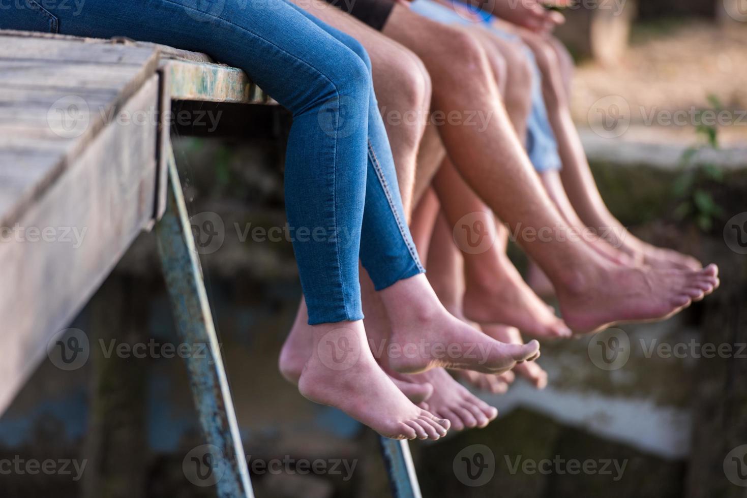 people sitting at wooden bridge photo