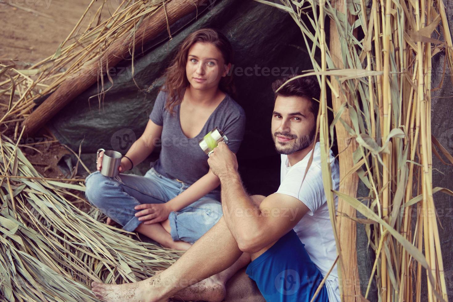 couple spending time together in straw tent photo