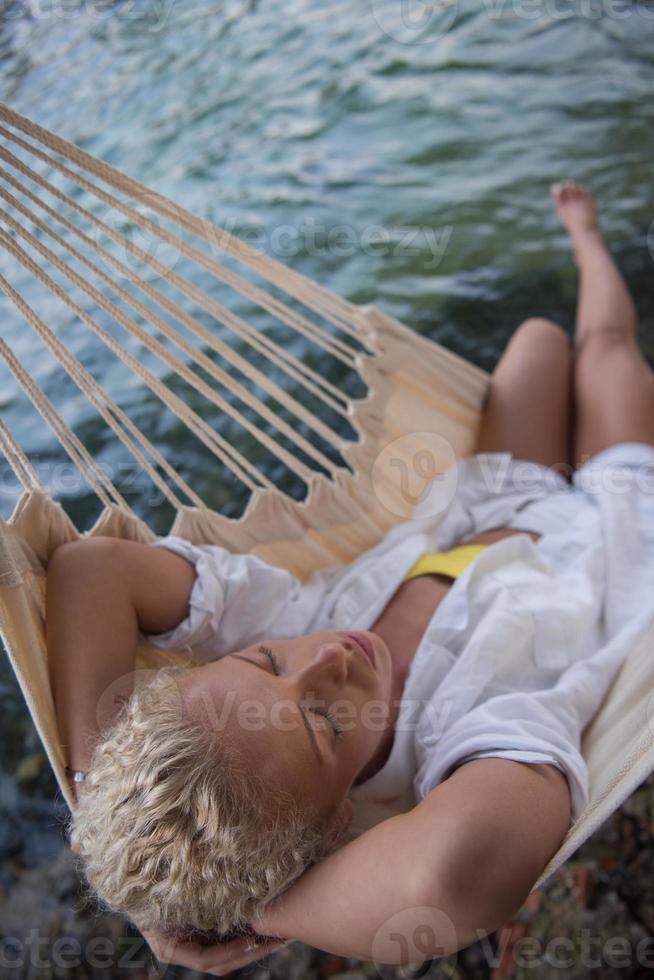 blonde woman resting on hammock photo