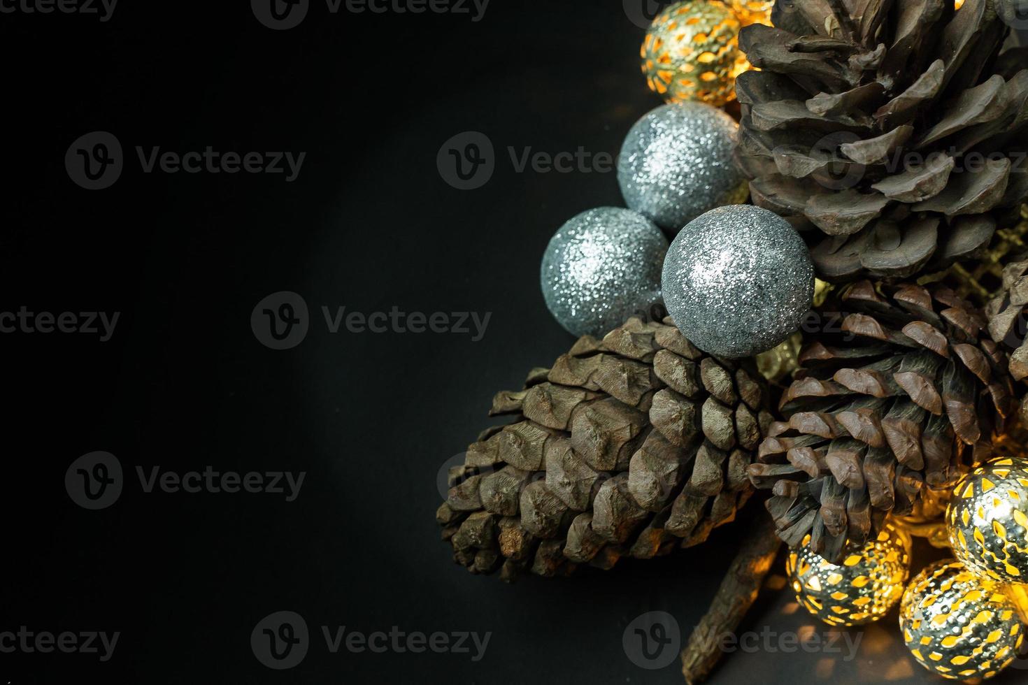 The christmas ball and Pine cones  on black  background. photo