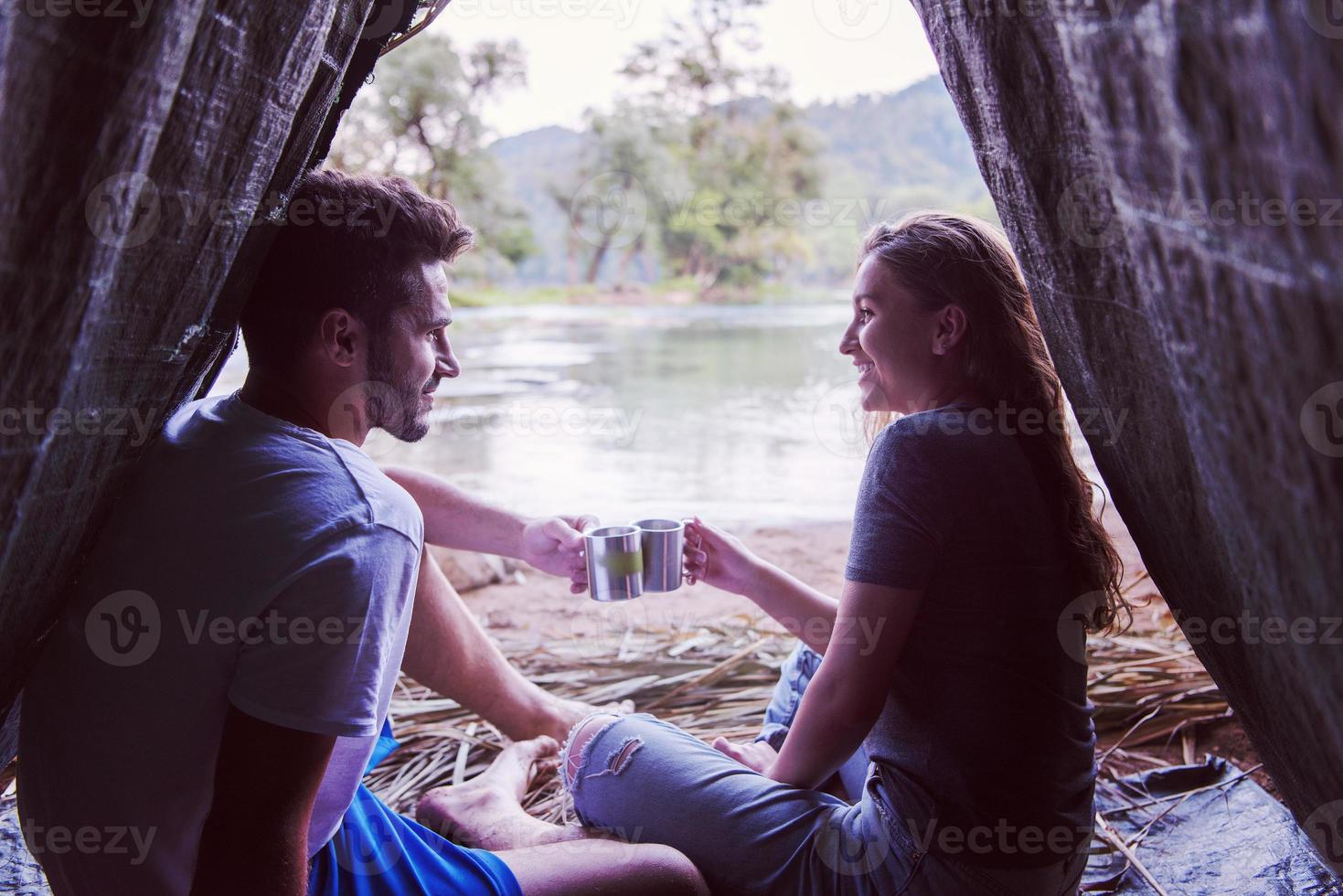 couple spending time together in straw tent photo
