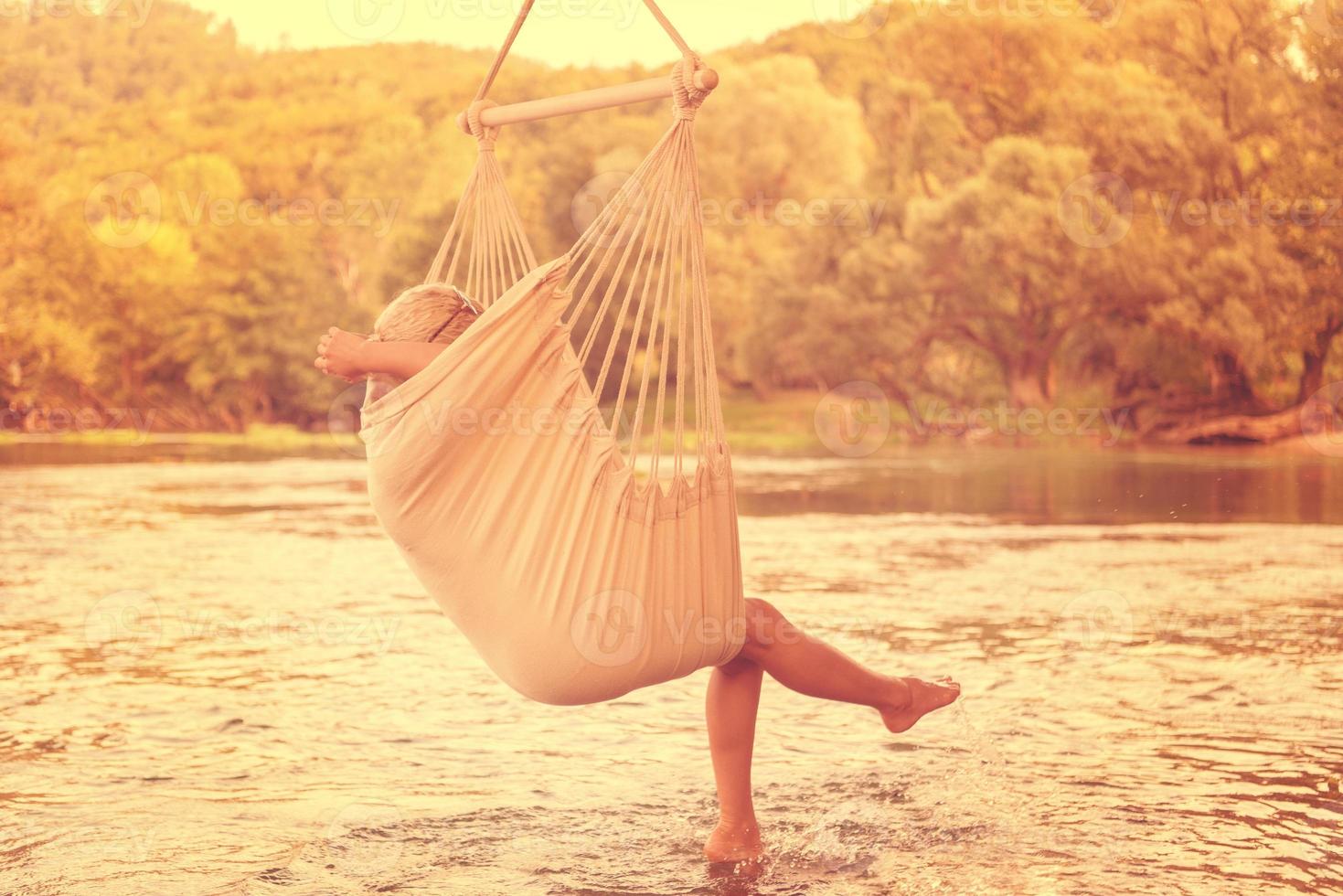 blonde woman resting on hammock photo