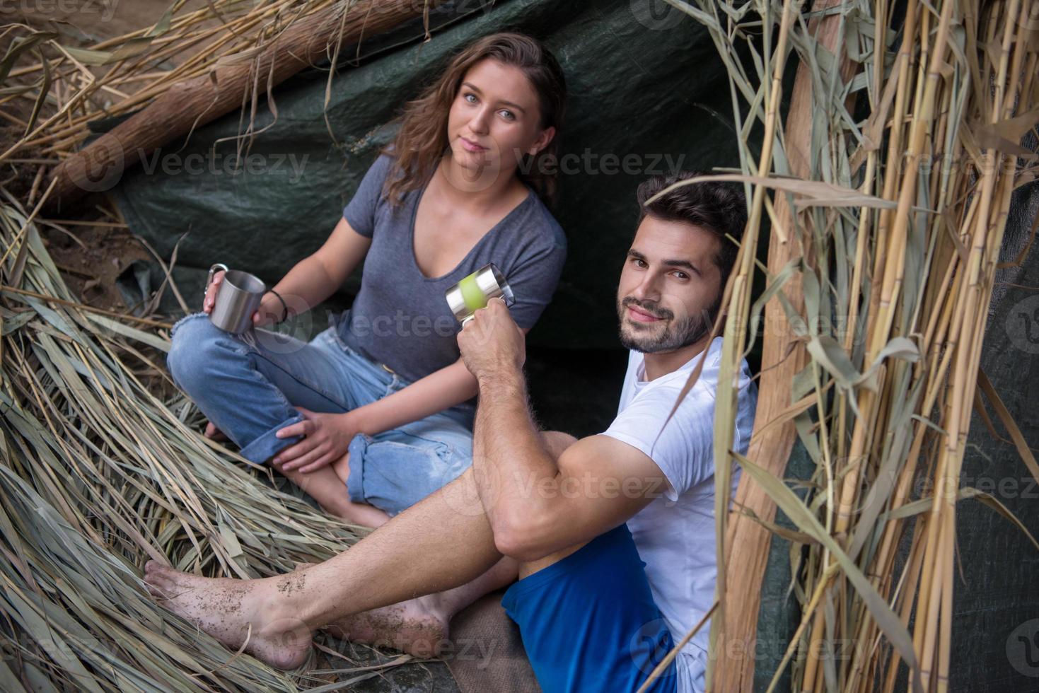 couple spending time together in straw tent photo