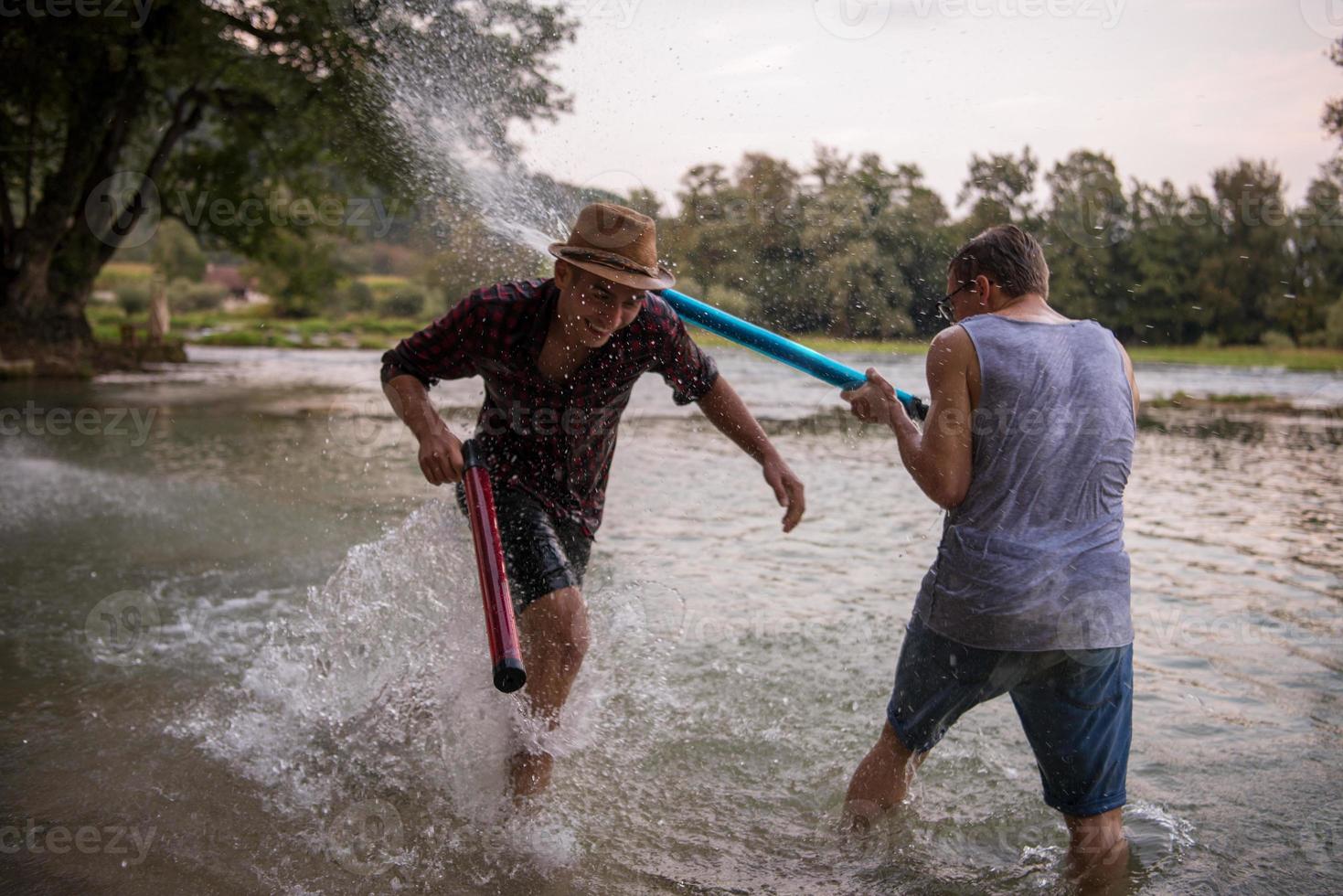 young men having fun with water guns photo